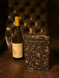 Pride and Prejudice by Jane Austen alongside a bottle of Carrière Pradal Les Cousins Viognier on a dark leather background