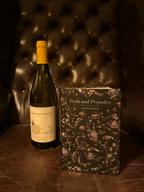 Pride and Prejudice by Jane Austen alongside a bottle of Carrière Pradal Les Cousins Viognier on a dark leather background