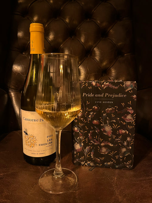 Pride and Prejudice with a poured glass of Viognier and the Carrière Pradal bottle on a dark leather background