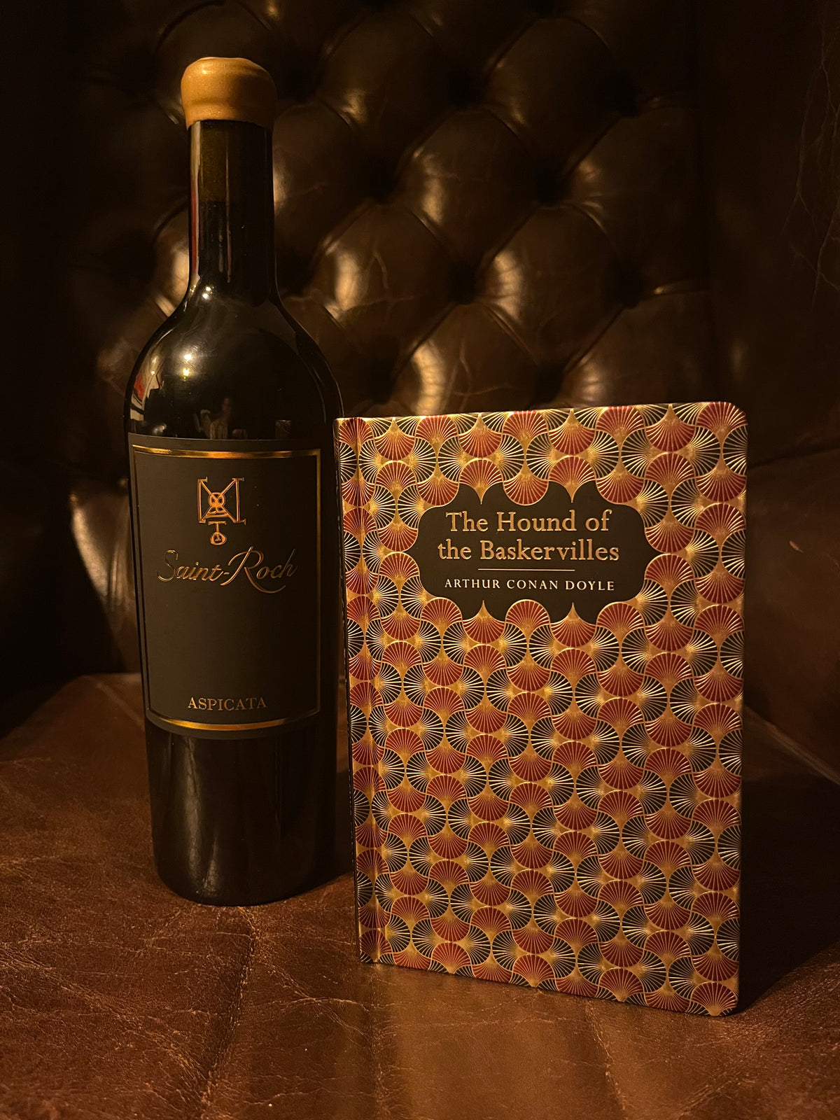 The Hound of the Baskervilles with Saint-Roch Aspicata wine and glass on leather
