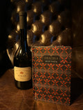 Dracula by Bram Stoker with Château Dereszla Tokaji Dry bottle on Chesterfield leather